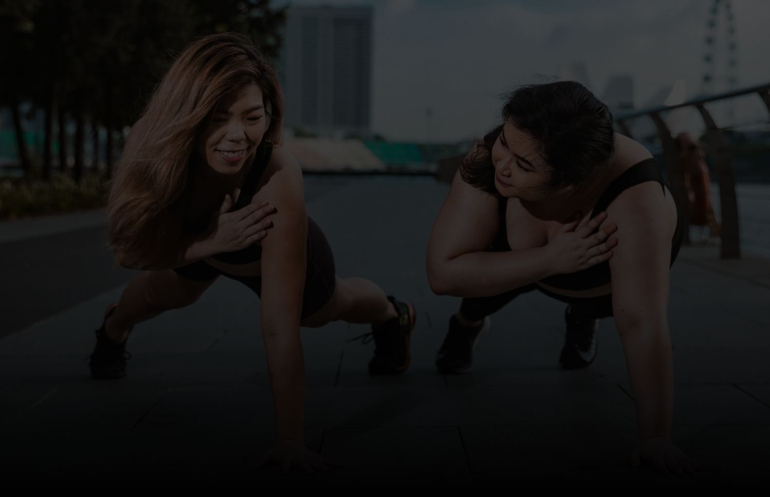 Two women training outdoors at MSFIT Singapore